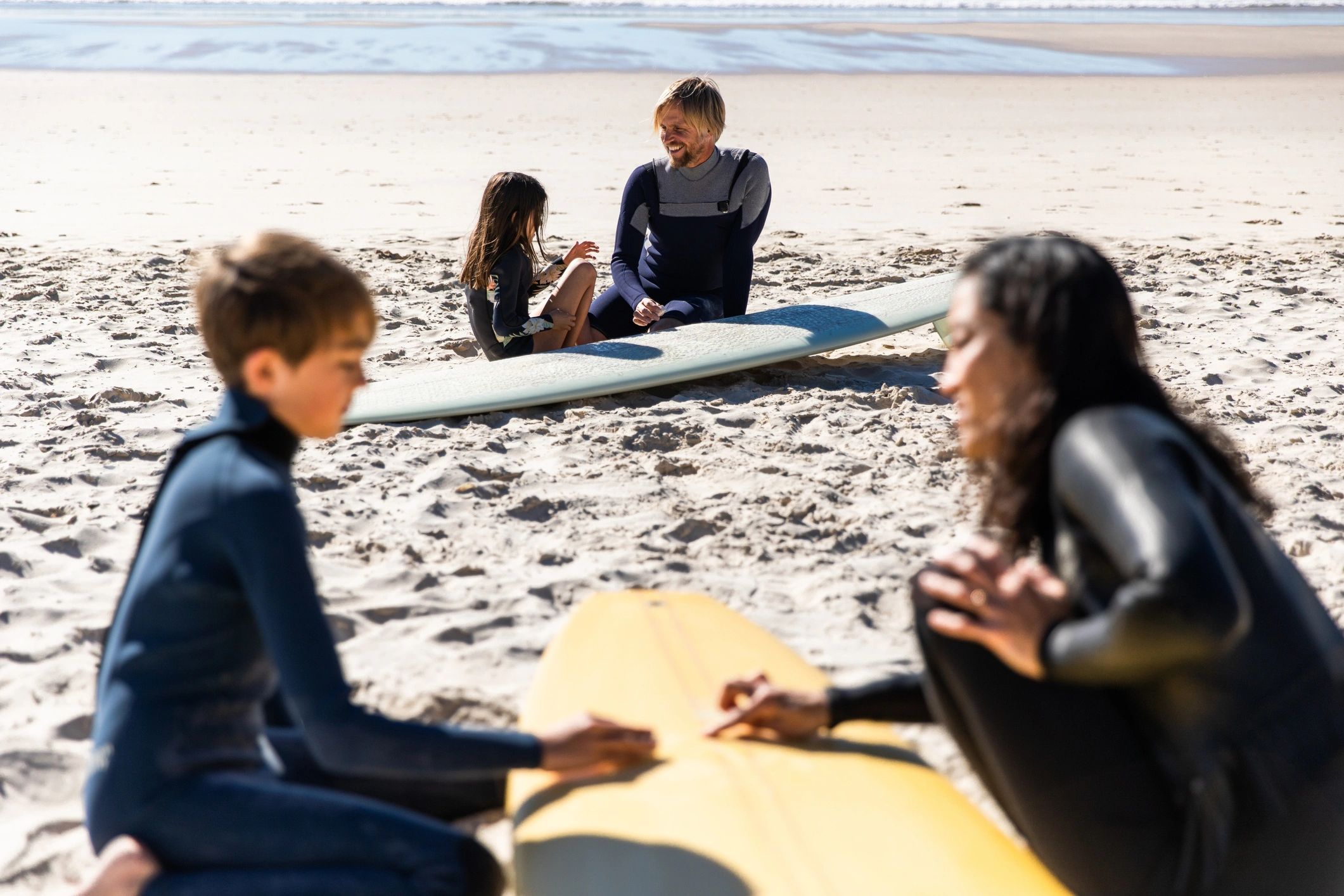 Parent and child preparing for a surf lesson